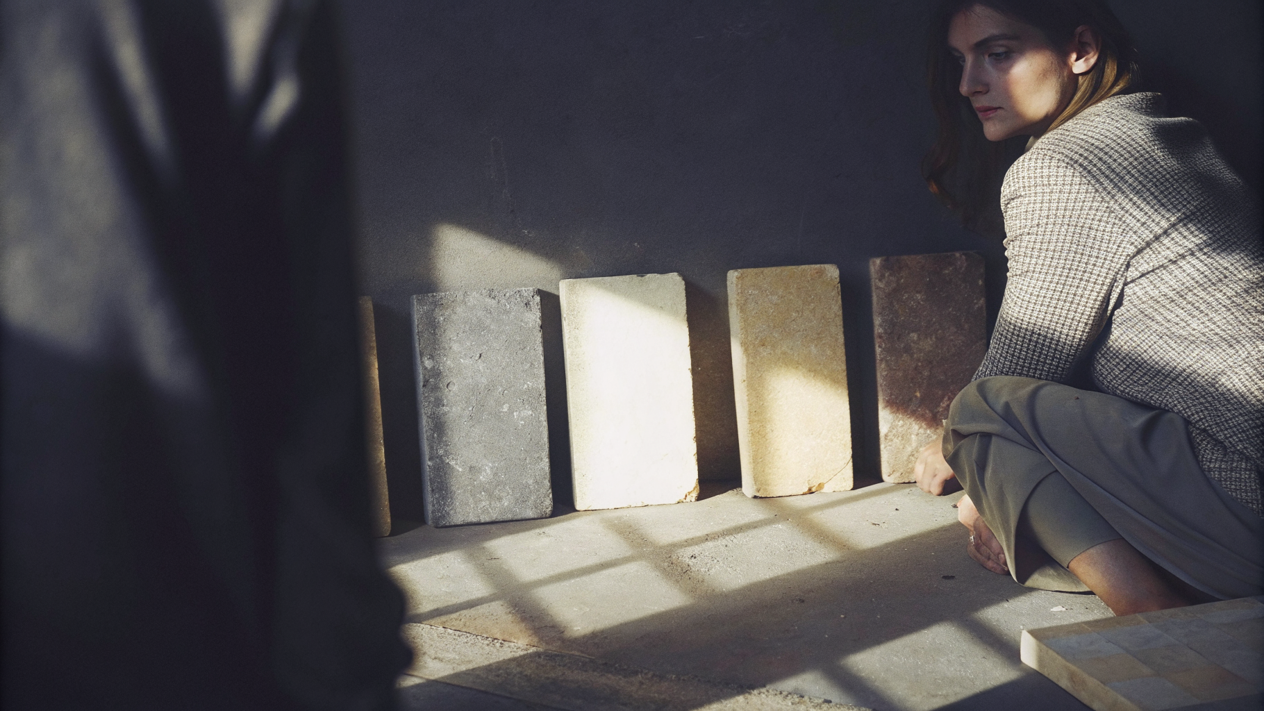 Editorial photograph of separated stone forms with gaps of shadow between them