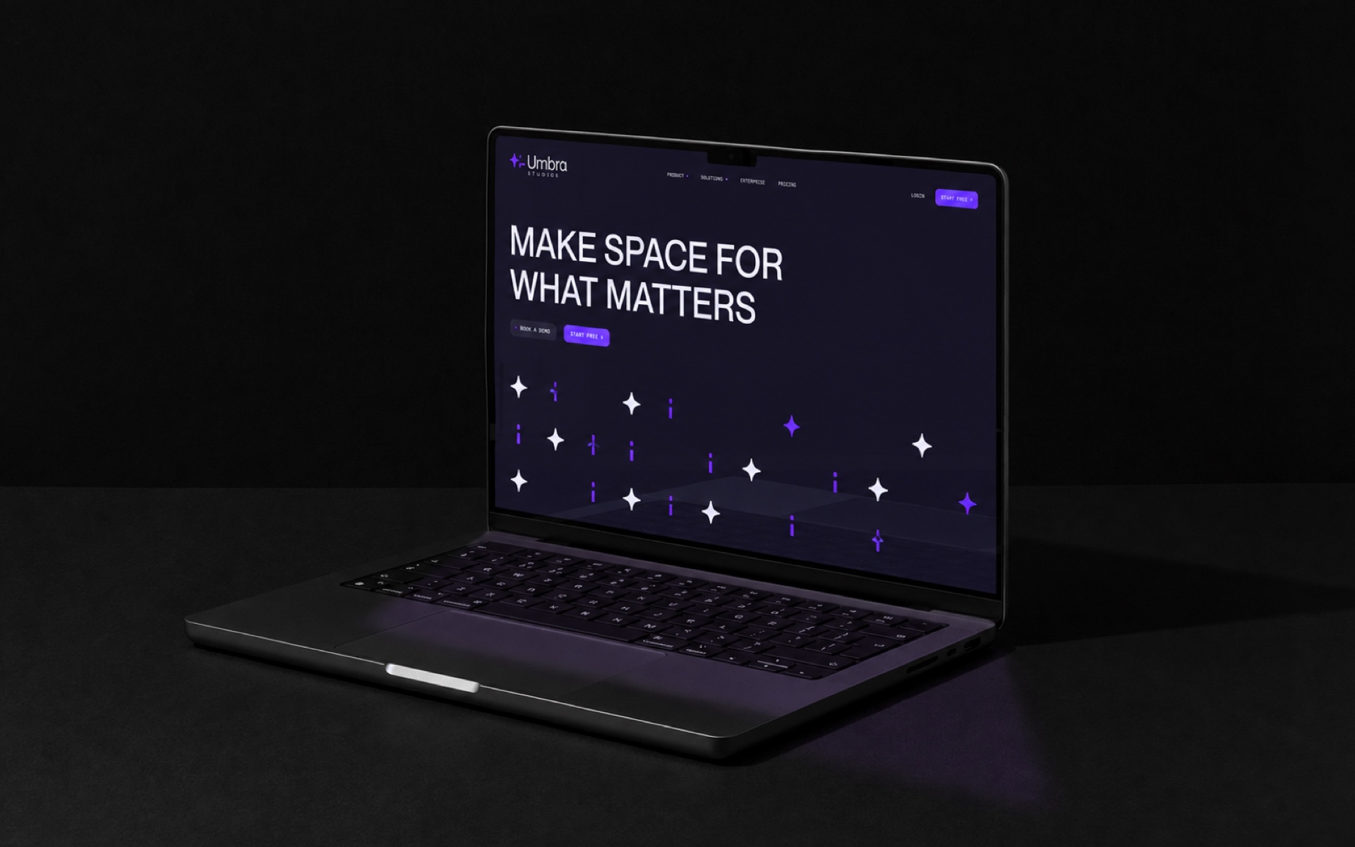 A dark website hero on a laptop, the headline and star motif carrying the brand